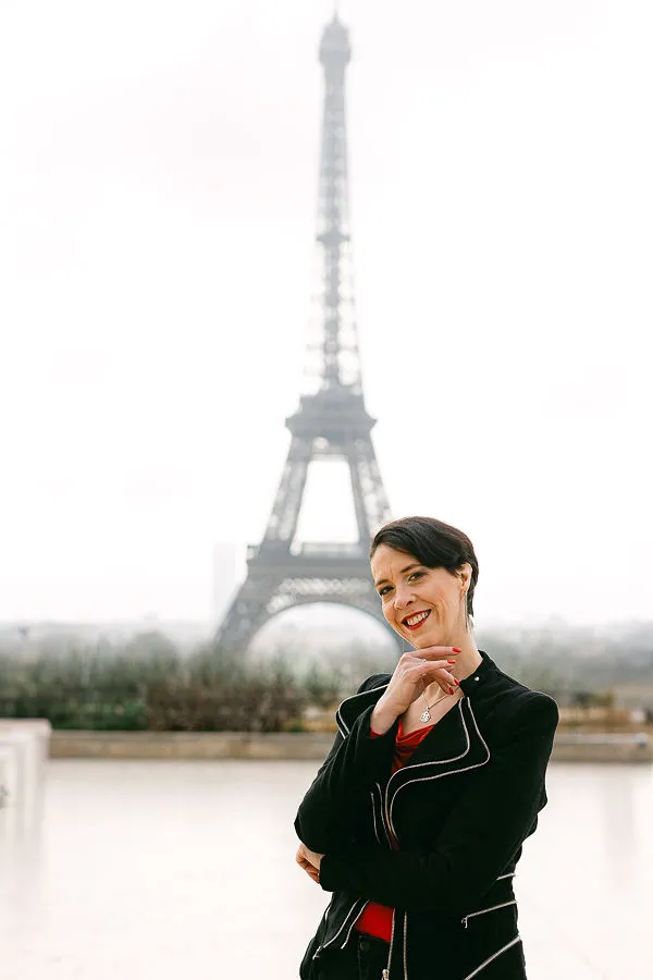 Estella Balbastre, wedding planner and ceremony celebrant, in front of the Eiffel Tower in Paris